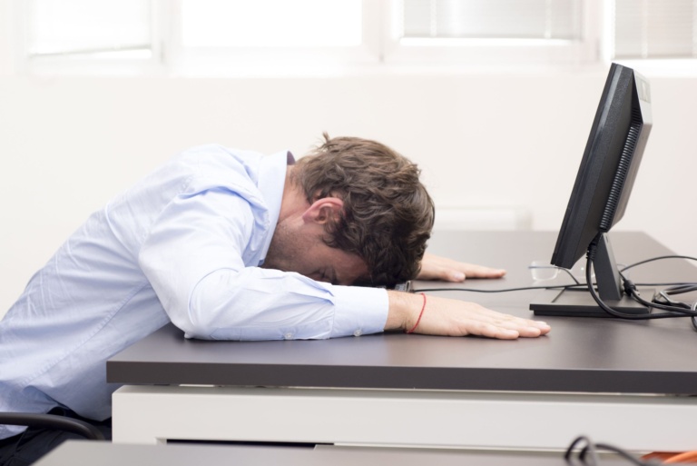 young-businessman-fallen-asleep-in-the-office-royalty-free-image-498614661-1536943554-1-scaled-1